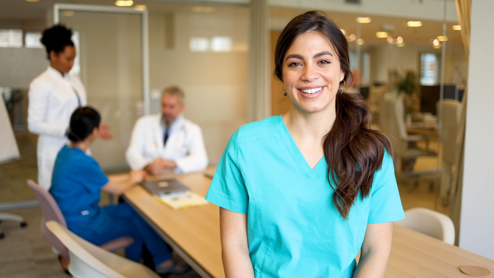 Happy nurse with her medical team